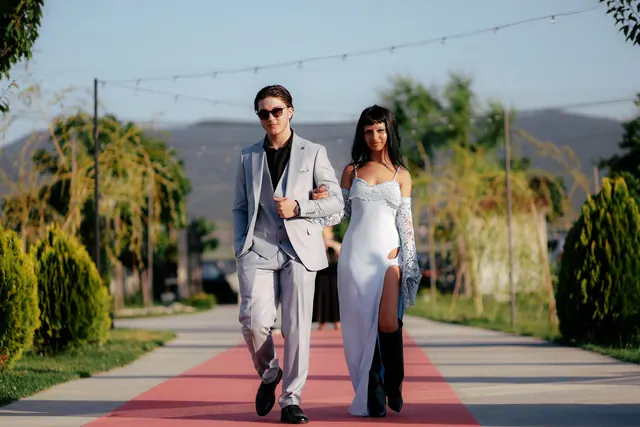 Stylish couple walking confidently on red carpet outdoors in elegant fashion. Award-show looks styles: a visual guide to the main options