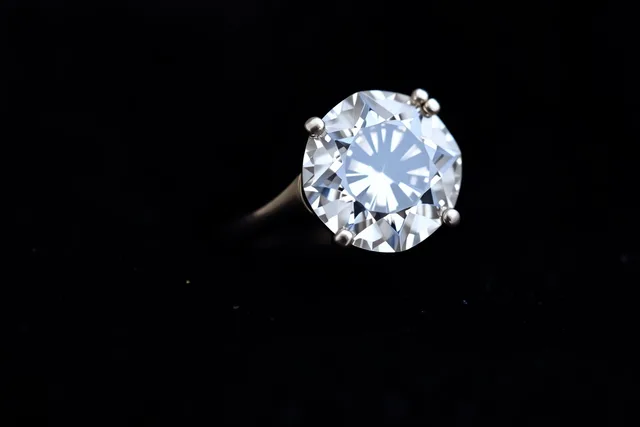 Macro view of a four-prong engagement ring setting holding a round diamond. Engagement rings ideas worth trying first